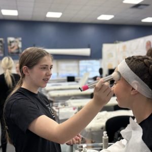 Two Home Ed learners practising makeup application during a VTCT Level 1 Hair & Beauty practical session at NSHB.